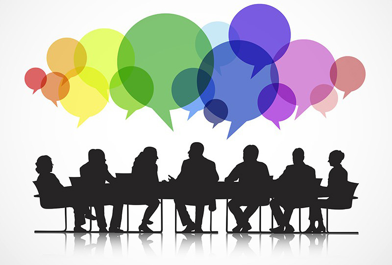 Silhouette of people around a table with speech bubbles above